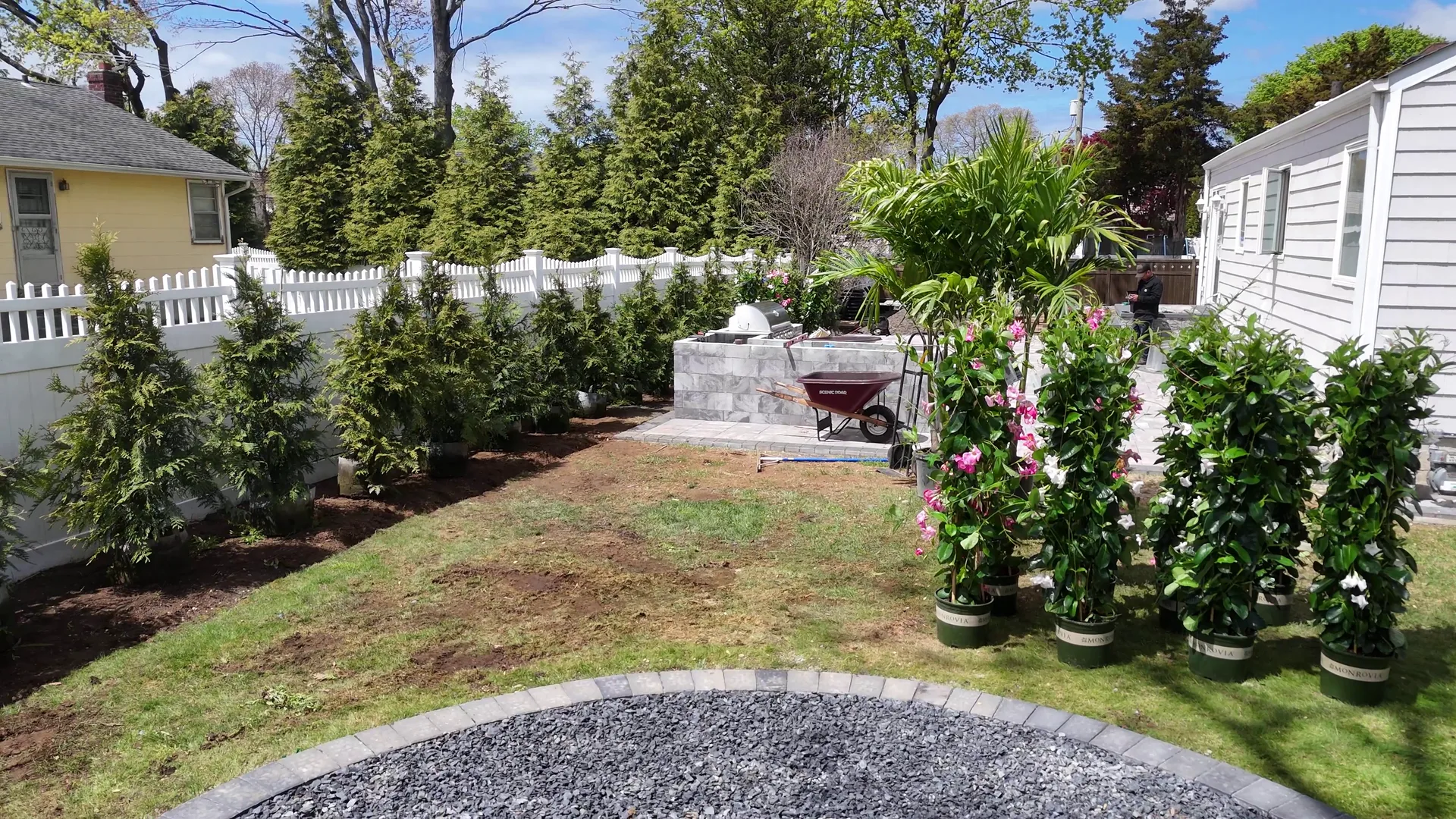 A finished outdoor living area with a built masonry fireplace and stone surround.